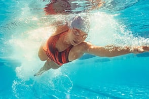 Mujer nadando en la piscina suba