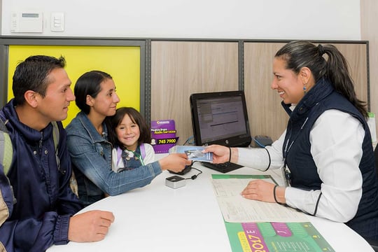 Una asesora de Colsubsidio atendiendo a una familia.