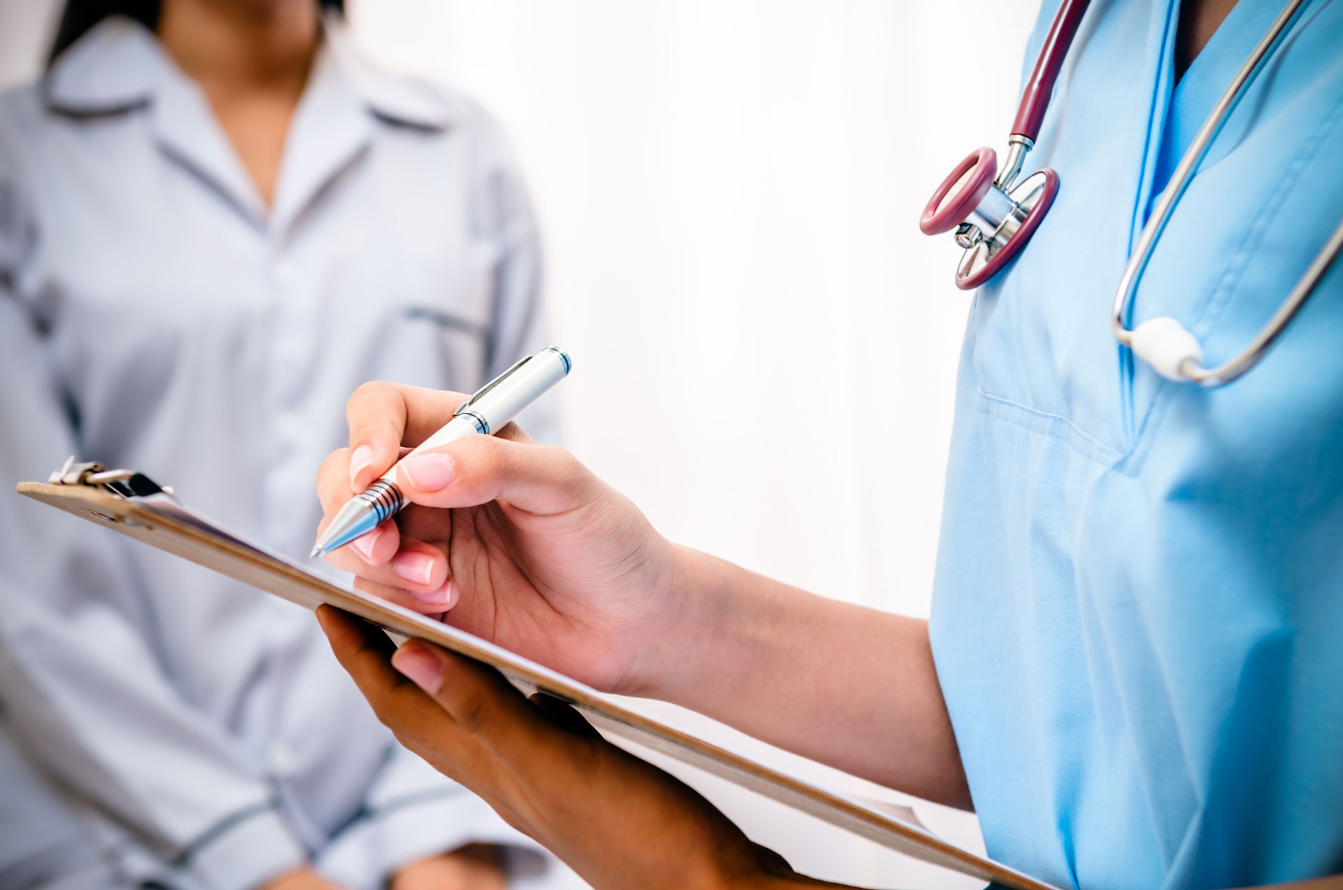 Un doctor escribiendo una receta médica para su paciente.